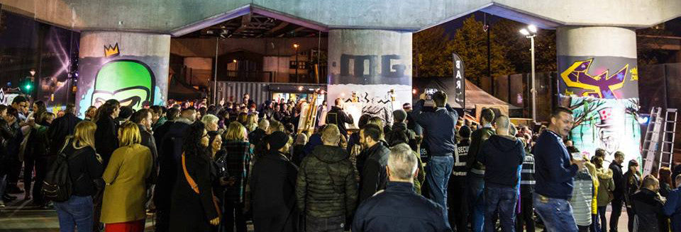 A photograph of crowds watching contenders at Art Battle 
