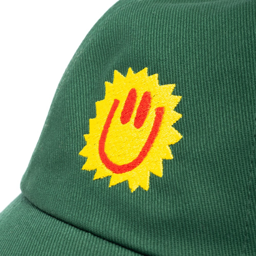 Green cap with a yellow and red logo on a white background