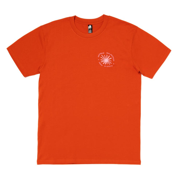 Orange t-shirt with a pink embroidered logo on a white background