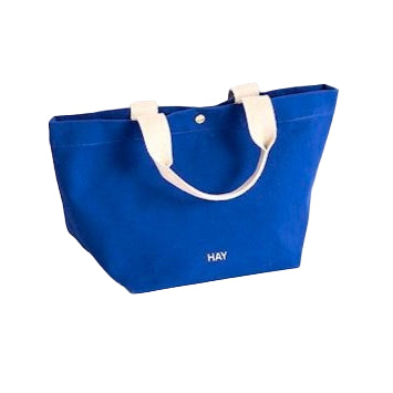 Electric Blue tote bag with white handles on a white background