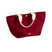 Burgundy tote bag with white handles on a white background