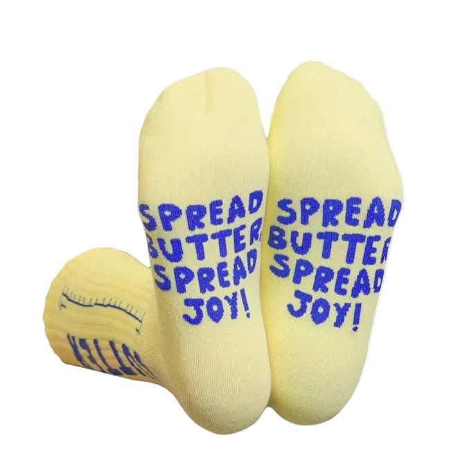 Yellow socks with blue text 'Spread Butter Spread Joy!' on a white background