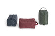 Three travel bags in different colors on a white background