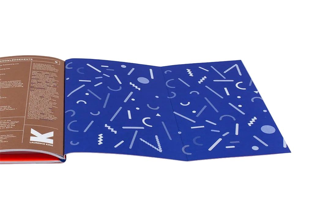 Open book with a blue page featuring white geometric patterns on a white background