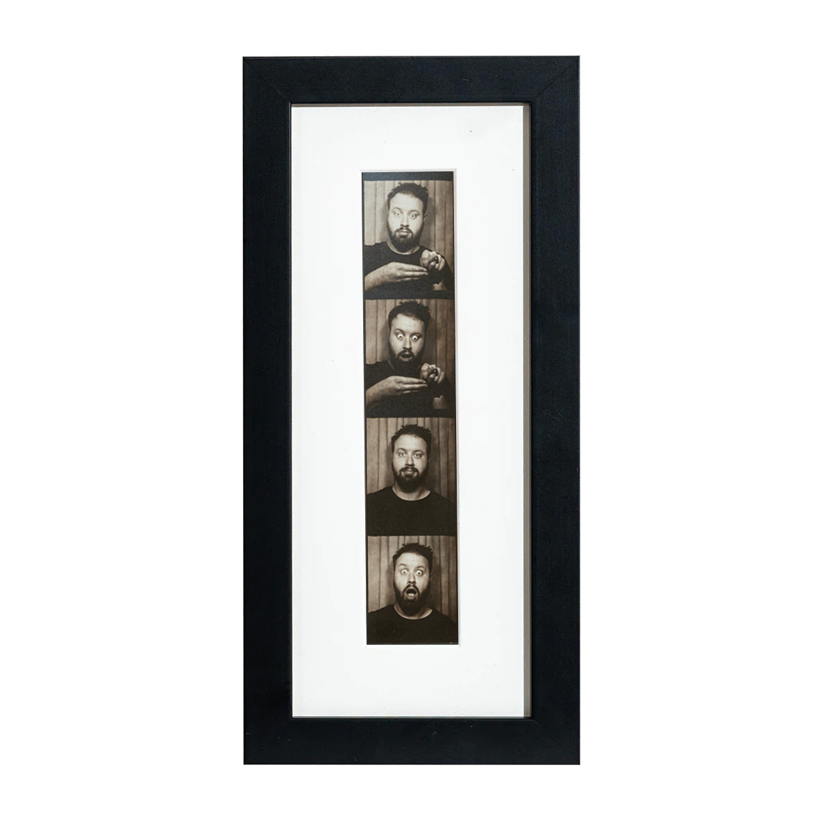 A black photobooth frame displaying a photo strip of multiple faces.