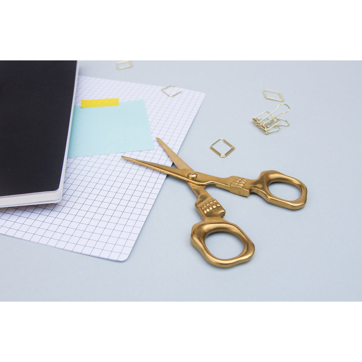 Open scissors with some stationery.
